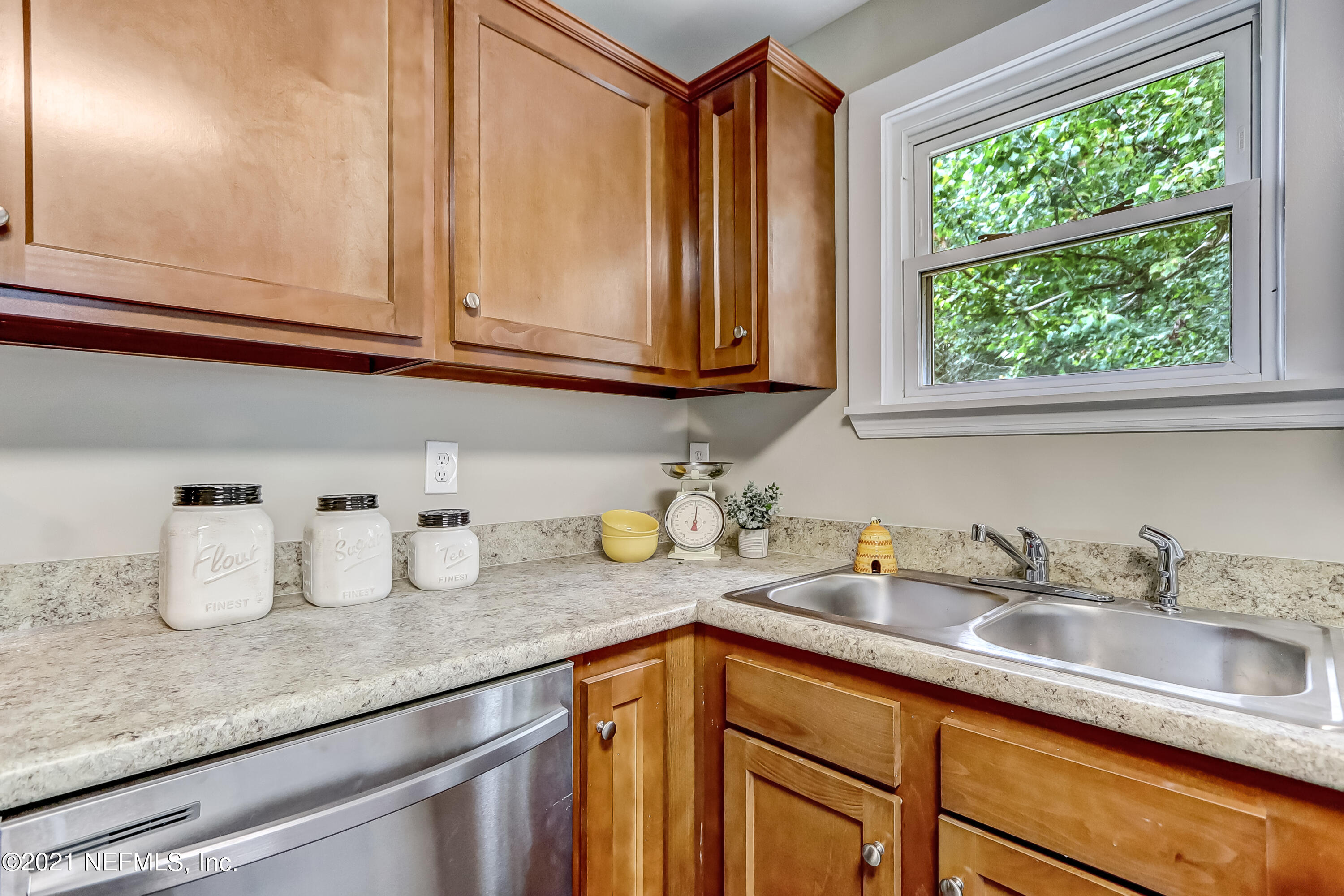 1416 Fred Gray Road Jacksonville, FL 32218 - Photo 21 of 34 a kitchen with granite countertop stainless steel appliances a sink window and cabinets