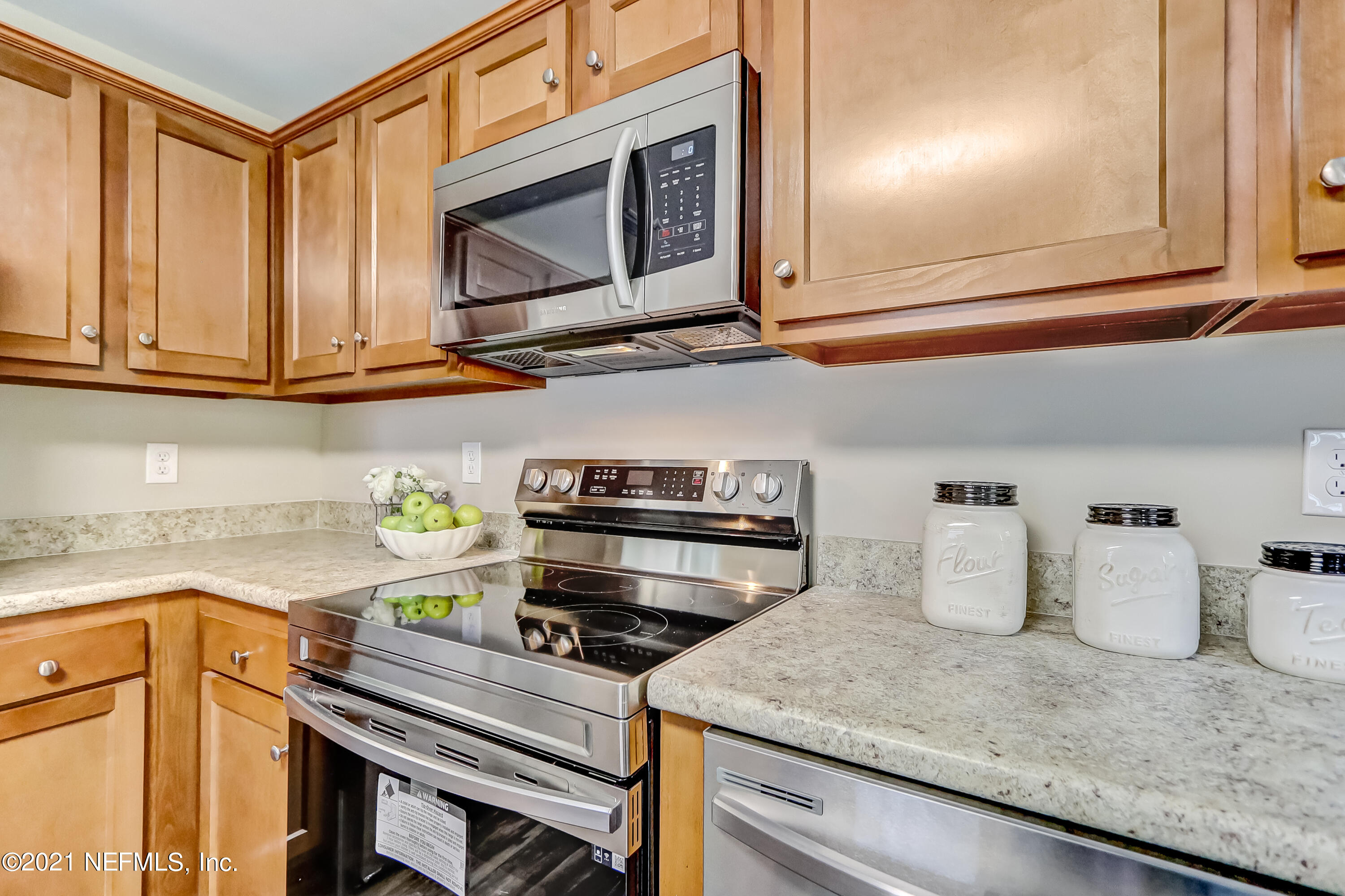 1416 Fred Gray Road Jacksonville, FL 32218 - Photo 22 of 34 a kitchen with a stove and a microwave