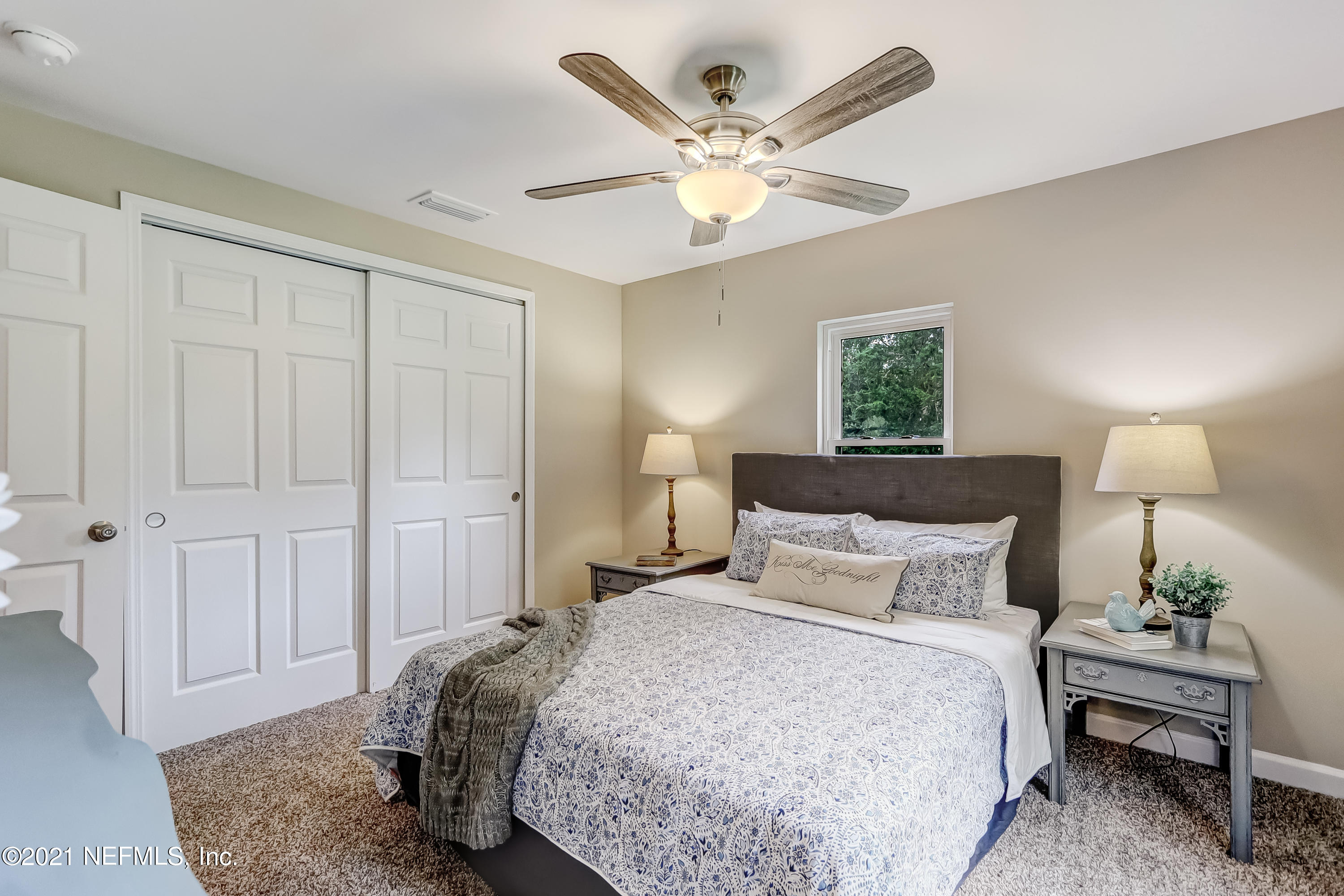 1416 Fred Gray Road Jacksonville, FL 32218 - Photo 24 of 34 a bedroom with a bed and a chandelier