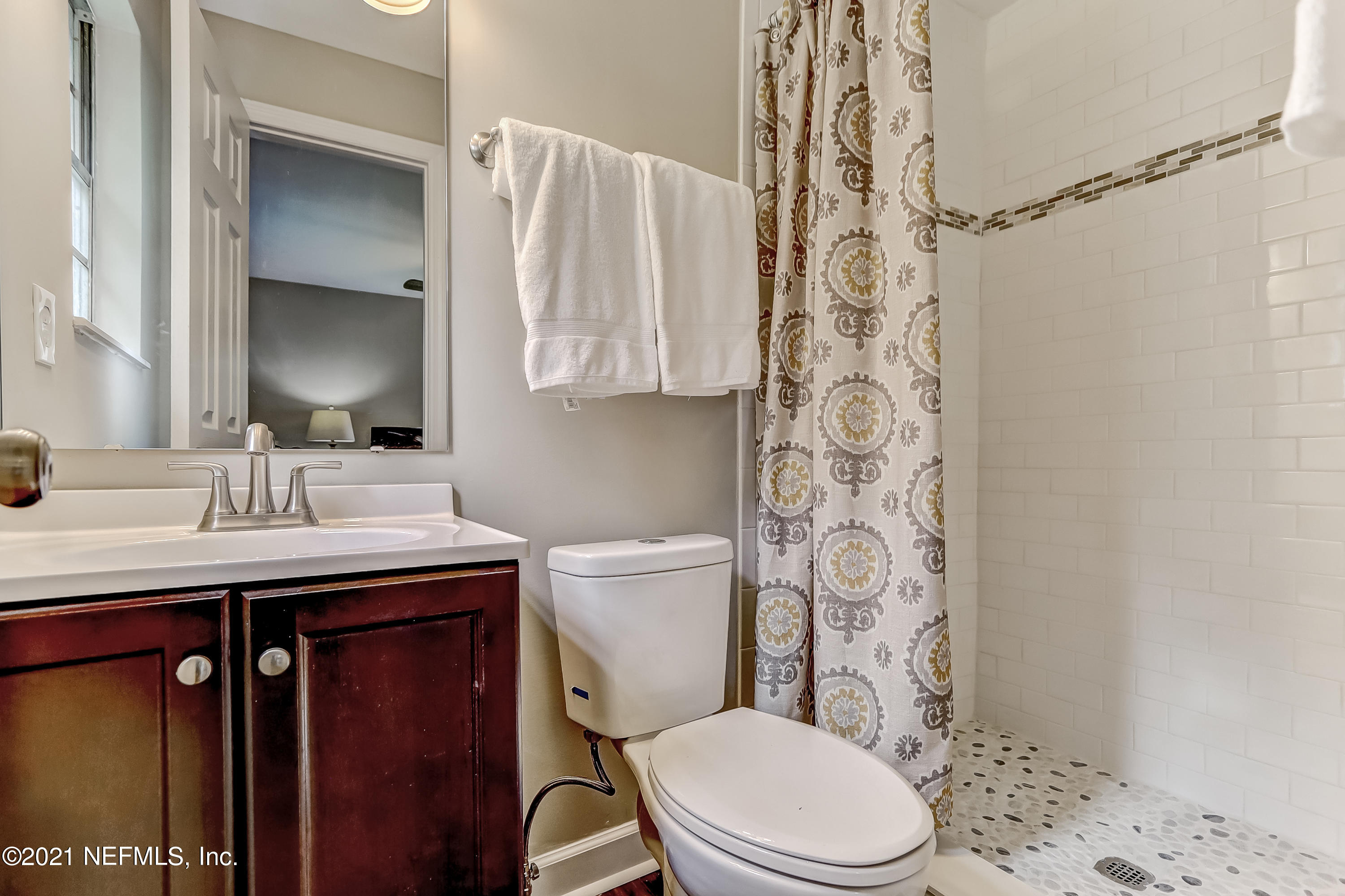 1416 Fred Gray Road Jacksonville, FL 32218 - Photo 25 of 34 a bathroom with a sink a toilet and shower curtain