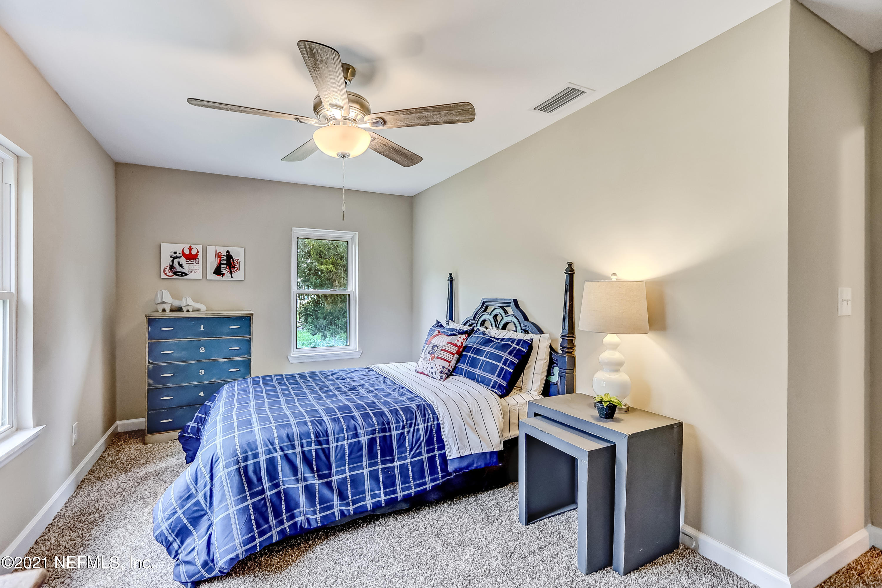 1416 Fred Gray Road Jacksonville, FL 32218 - Photo 31 of 34 a bedroom with a bed and a chandelier