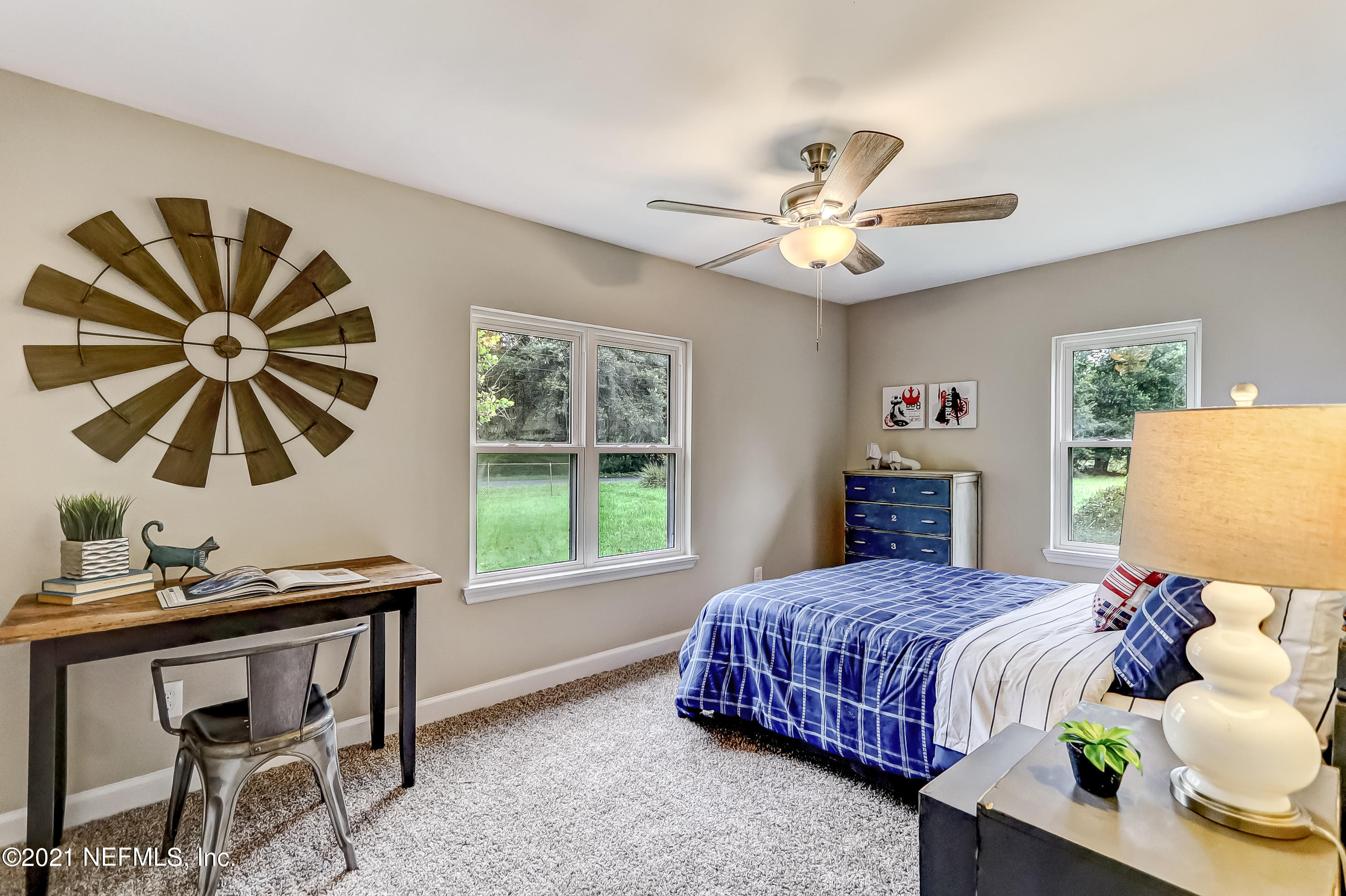 1416 Fred Gray Road Jacksonville, FL 32218 - Photo 32 of 34 a bedroom with a bed and a chandelier