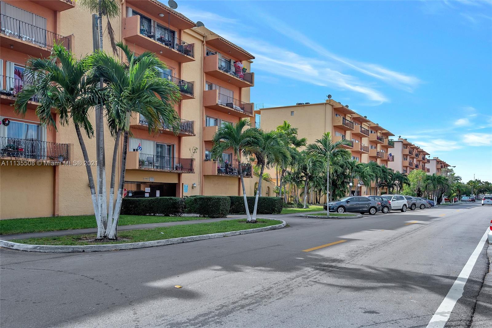 1900 West 54th Street, Unit 307 Hialeah, FL 33012 - Photo 2 of 49 a palm tree sitting in front of a building