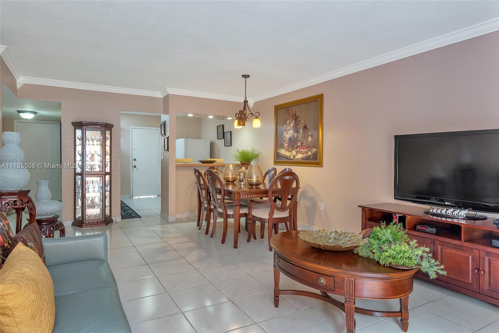 1900 West 54th Street, Unit 307 Hialeah, FL 33012 - Photo 17 of 49 a living room with furniture and a flat screen tv