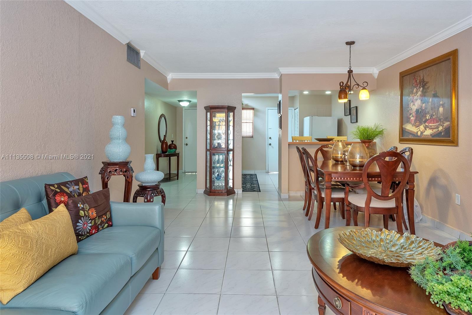 1900 West 54th Street, Unit 307 Hialeah, FL 33012 - Photo 18 of 49 a living room with furniture and a chandelier