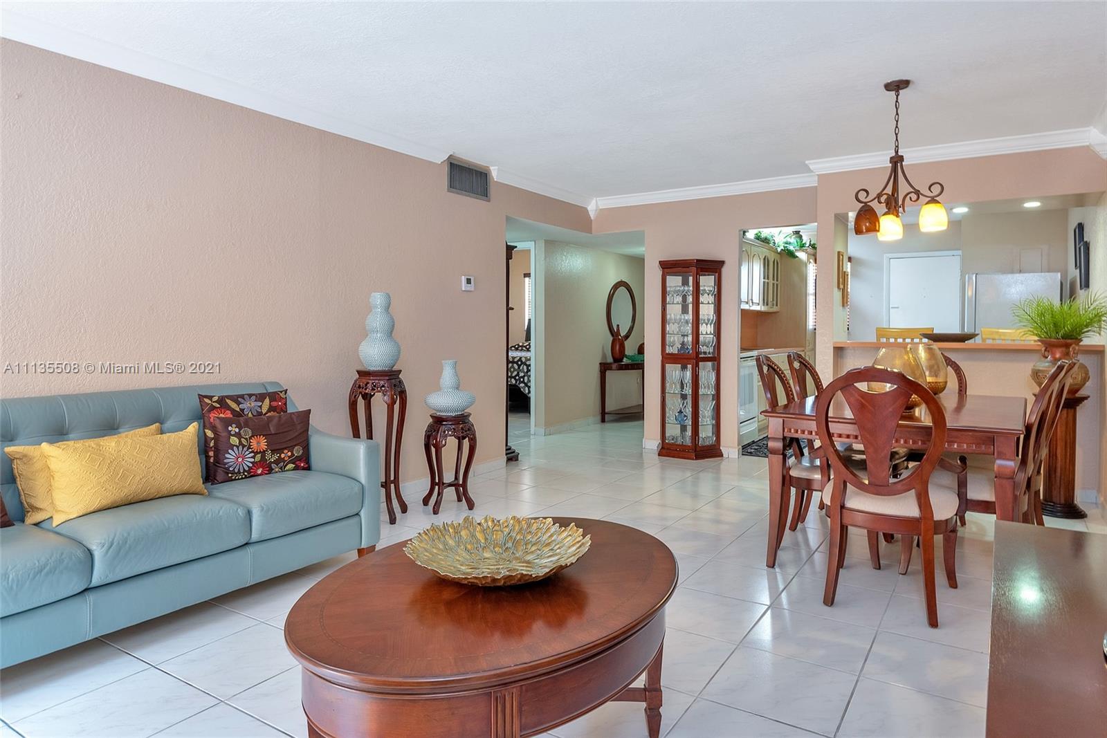 1900 West 54th Street, Unit 307 Hialeah, FL 33012 - Photo 19 of 49 a living room with furniture and a wooden floor