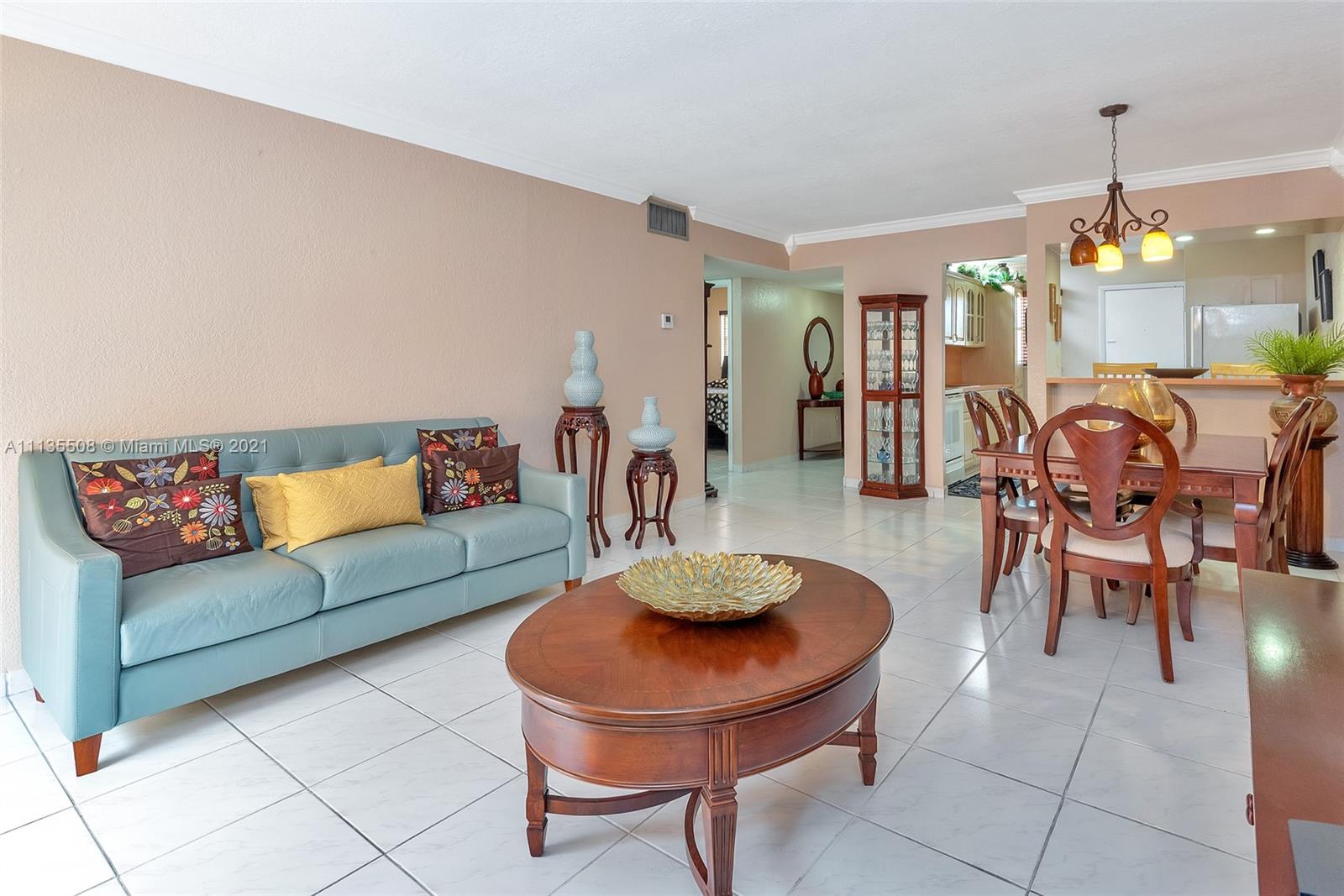 1900 West 54th Street, Unit 307 Hialeah, FL 33012 - Photo 20 of 49 a living room with furniture a chandelier and a dining table