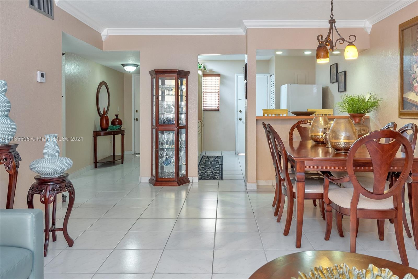 1900 West 54th Street, Unit 307 Hialeah, FL 33012 - Photo 21 of 49 a view of a dining room with furniture and chandelier