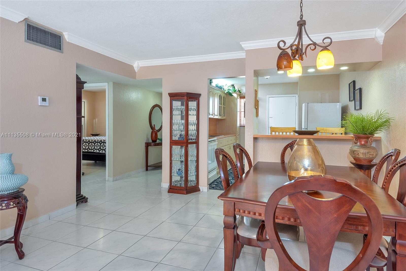 1900 West 54th Street, Unit 307 Hialeah, FL 33012 - Photo 22 of 49 a view of a dining room with furniture and chandelier