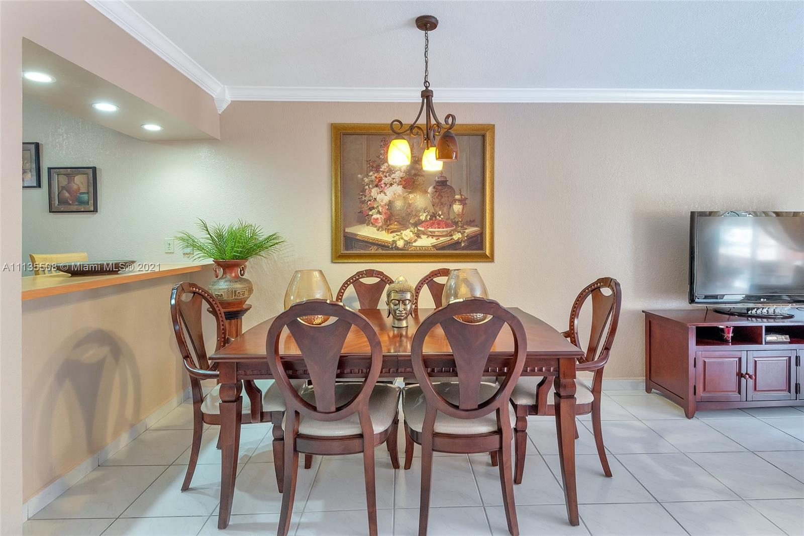 1900 West 54th Street, Unit 307 Hialeah, FL 33012 - Photo 23 of 49 a view of a dining room with furniture and chandelier