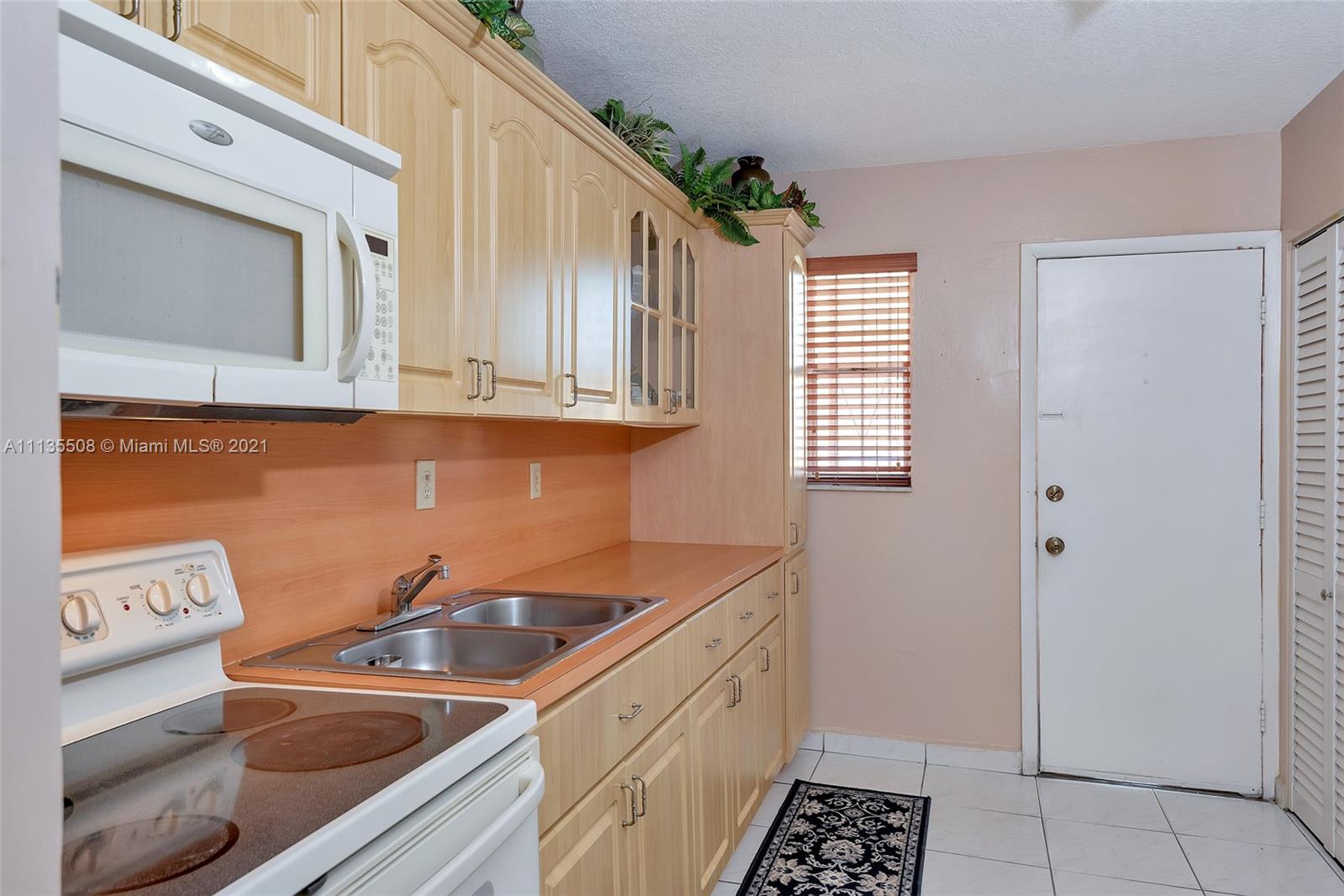 1900 West 54th Street, Unit 307 Hialeah, FL 33012 - Photo 25 of 49 a kitchen that has a sink and a stove