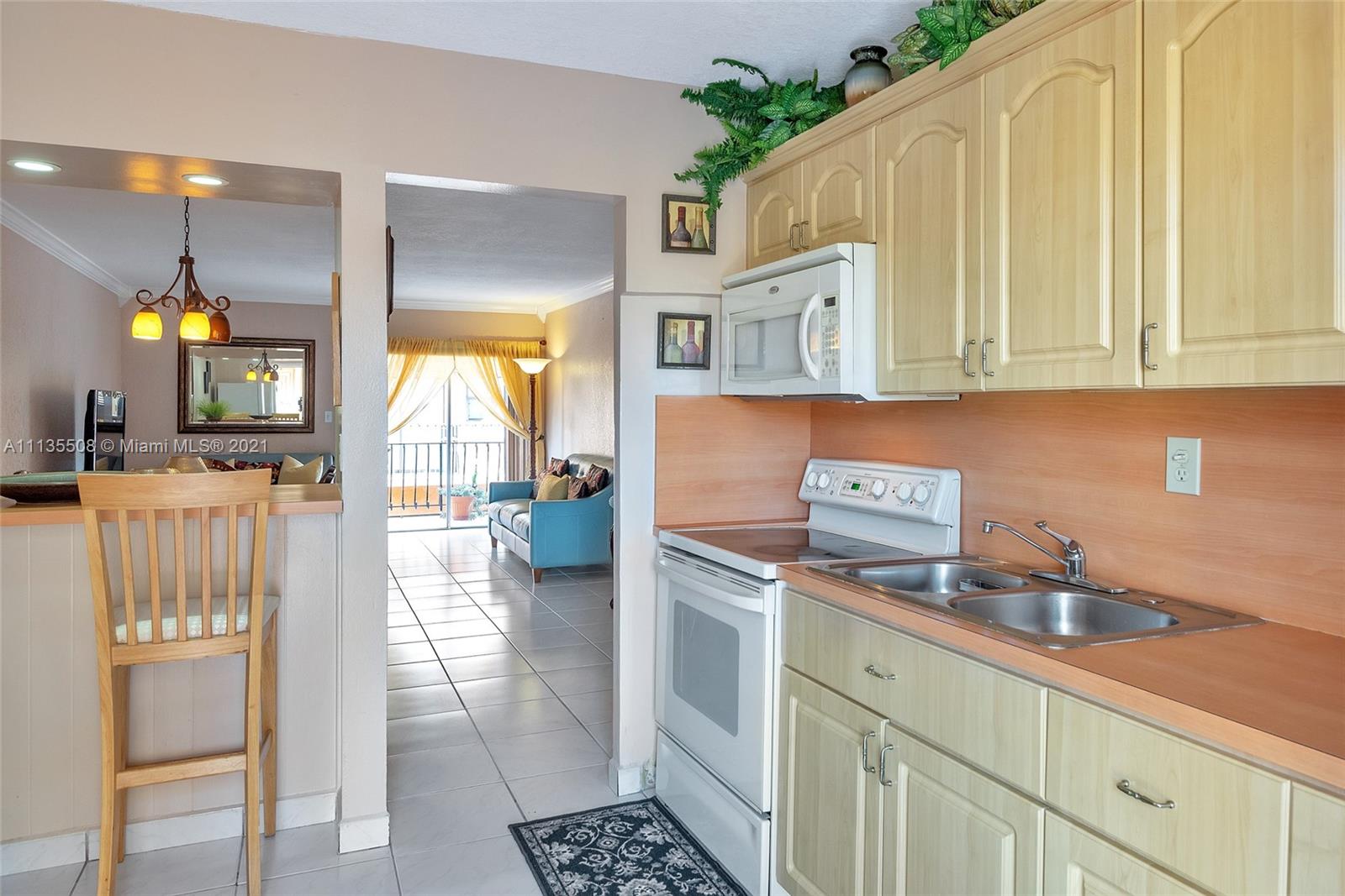 1900 West 54th Street, Unit 307 Hialeah, FL 33012 - Photo 28 of 49 a kitchen with a sink cabinets and window