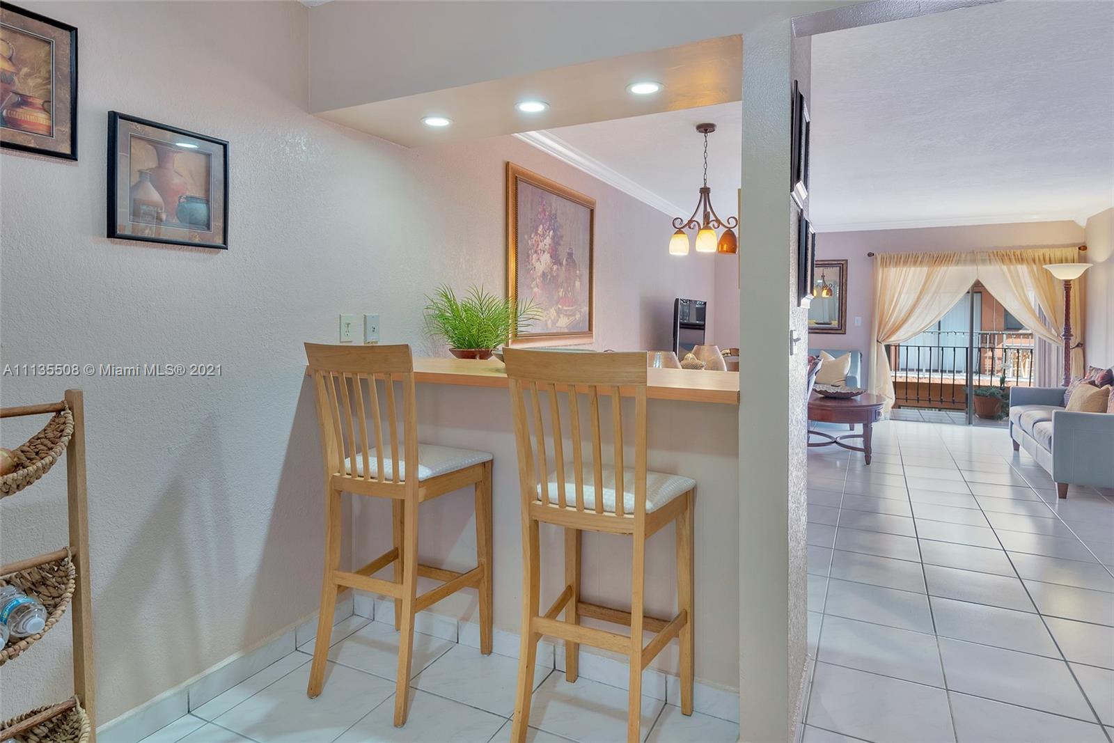 1900 West 54th Street, Unit 307 Hialeah, FL 33012 - Photo 29 of 49 a view of a dining room with furniture and a potted plant