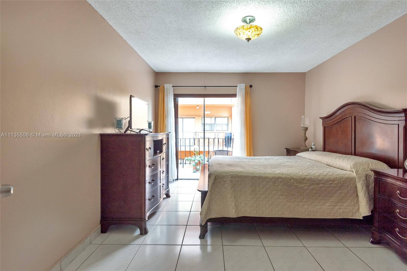 1900 West 54th Street, Unit 307 Hialeah, FL 33012 - Photo 32 of 49 a bedroom with a bed and a window