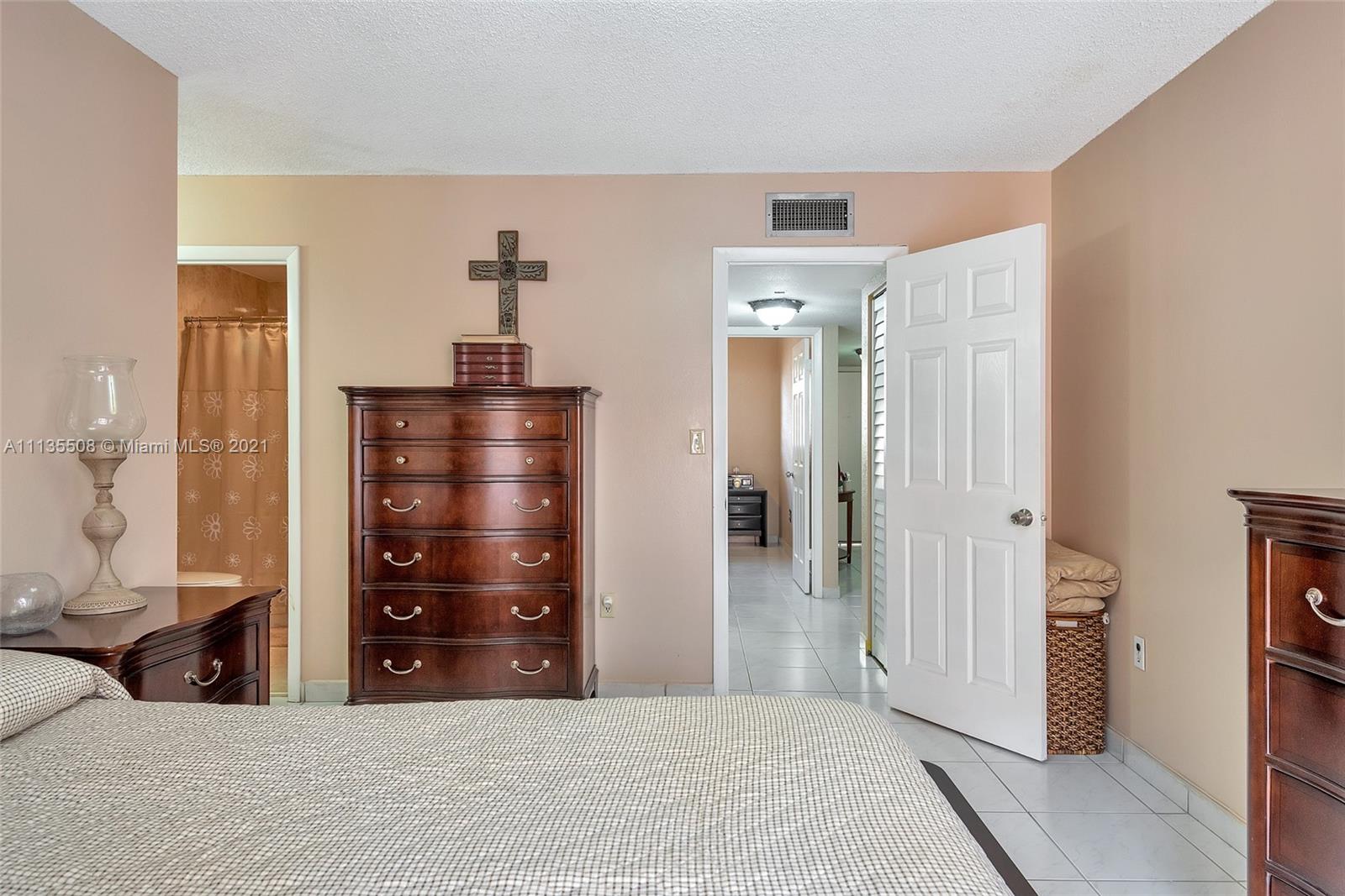 1900 West 54th Street, Unit 307 Hialeah, FL 33012 - Photo 35 of 49 a bedroom with a bed and a dresser