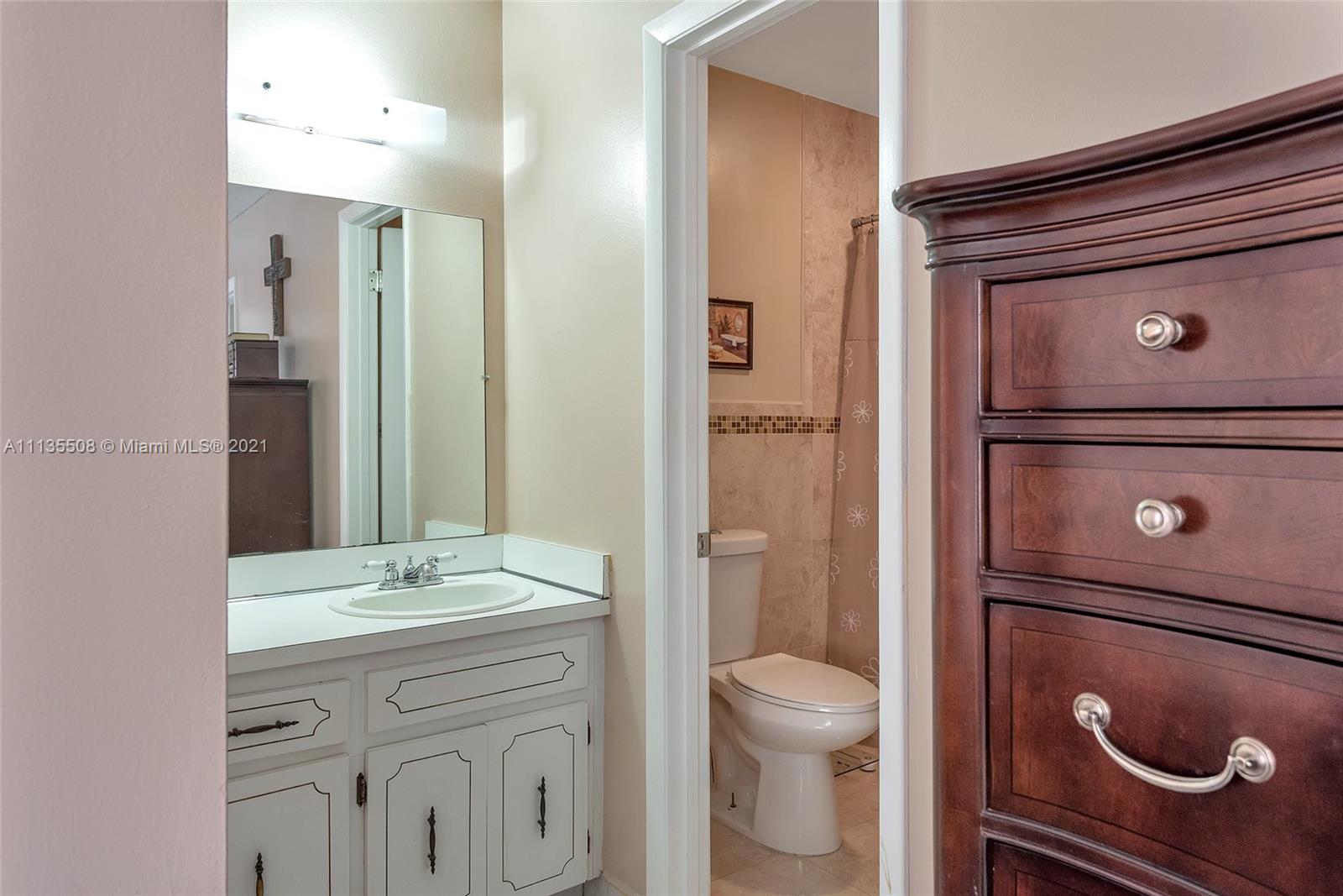 1900 West 54th Street, Unit 307 Hialeah, FL 33012 - Photo 36 of 49 a bathroom with a sink a toilet and shower