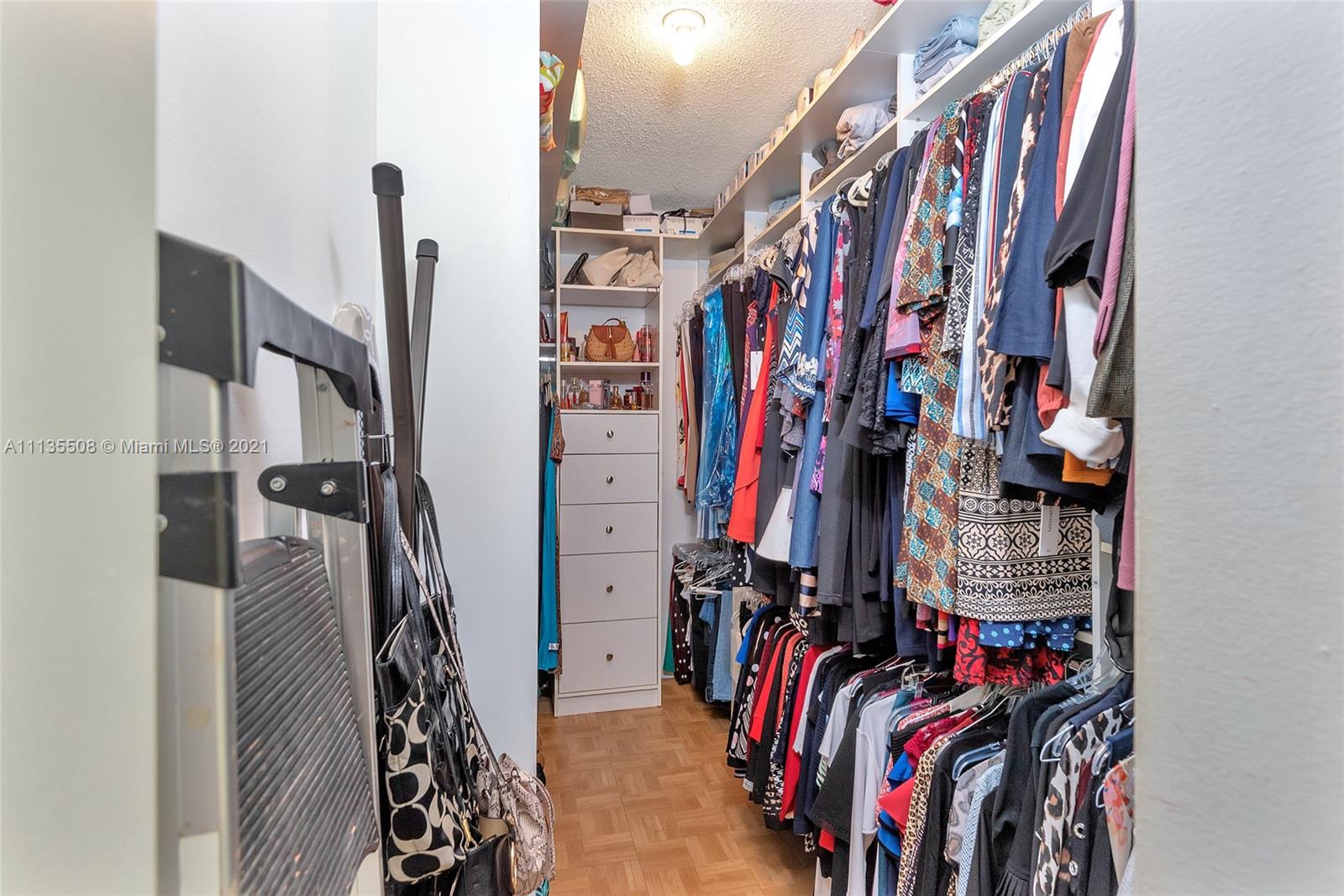 1900 West 54th Street, Unit 307 Hialeah, FL 33012 - Photo 40 of 49 a view of walk in closet with clothes