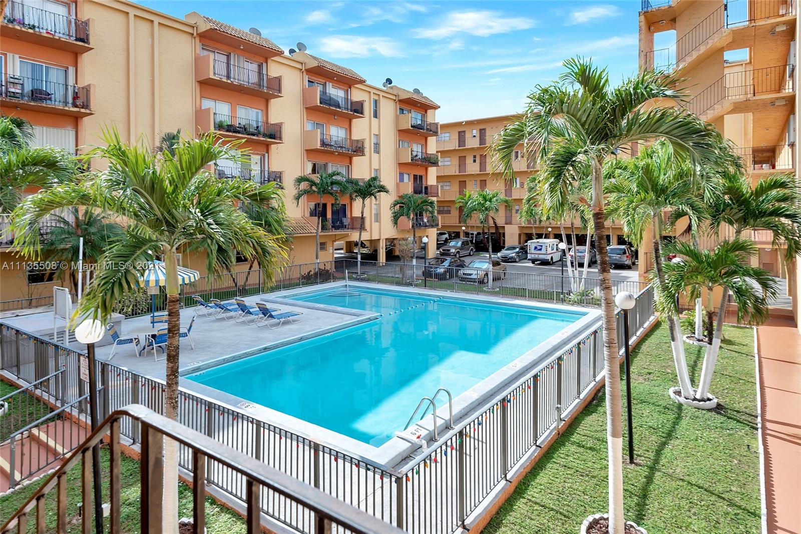 1900 West 54th Street, Unit 307 Hialeah, FL 33012 - Photo 5 of 49 a view of a swimming pool with a lounge chairs