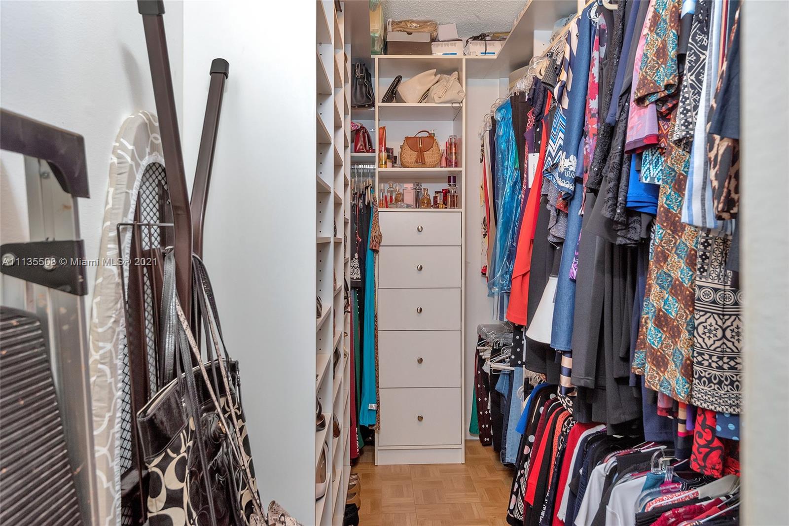1900 West 54th Street, Unit 307 Hialeah, FL 33012 - Photo 41 of 49 a view of walk in closet with clothes