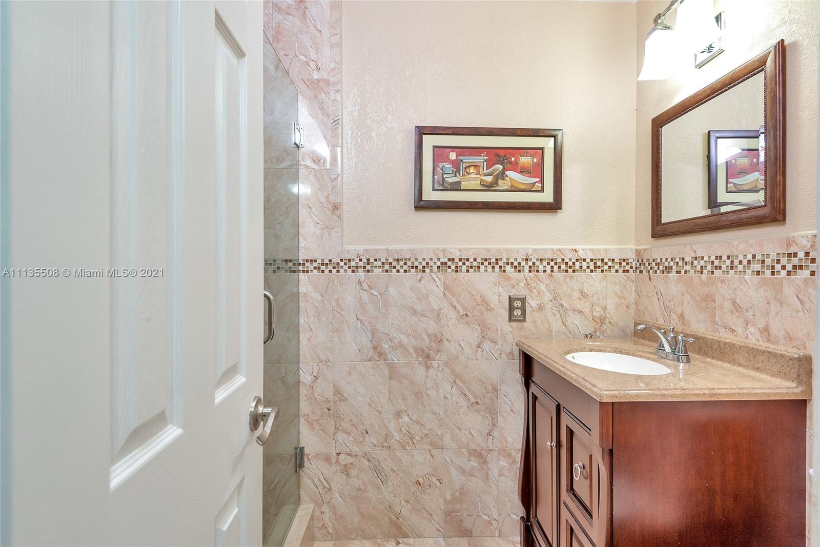 1900 West 54th Street, Unit 307 Hialeah, FL 33012 - Photo 42 of 49 a bathroom with a sink and a mirror