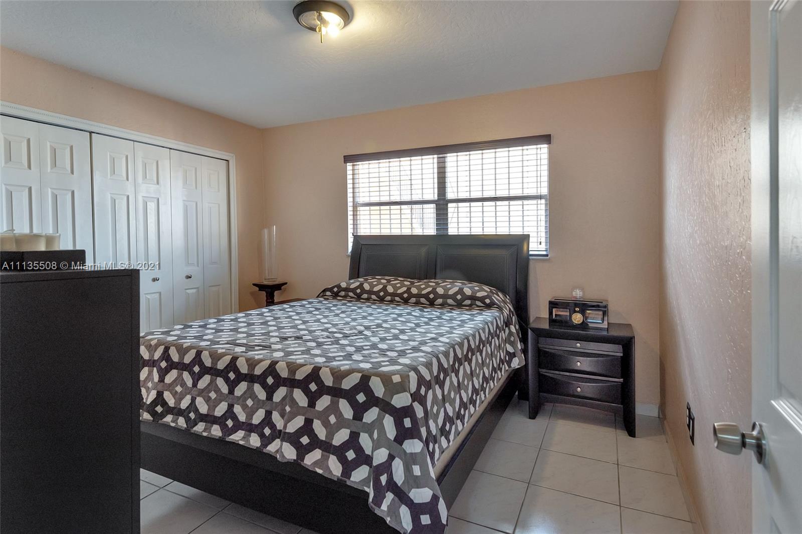 1900 West 54th Street, Unit 307 Hialeah, FL 33012 - Photo 45 of 49 a bedroom with a bed and a window