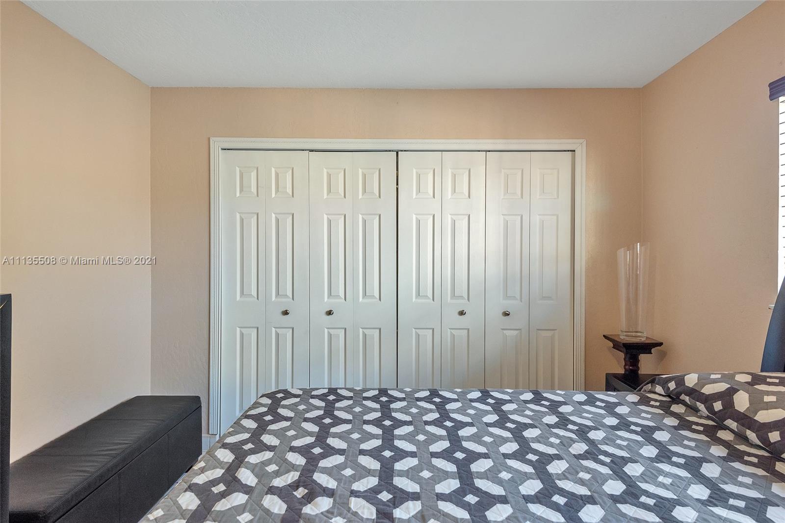 1900 West 54th Street, Unit 307 Hialeah, FL 33012 - Photo 46 of 49 a bedroom with a bed and a closet