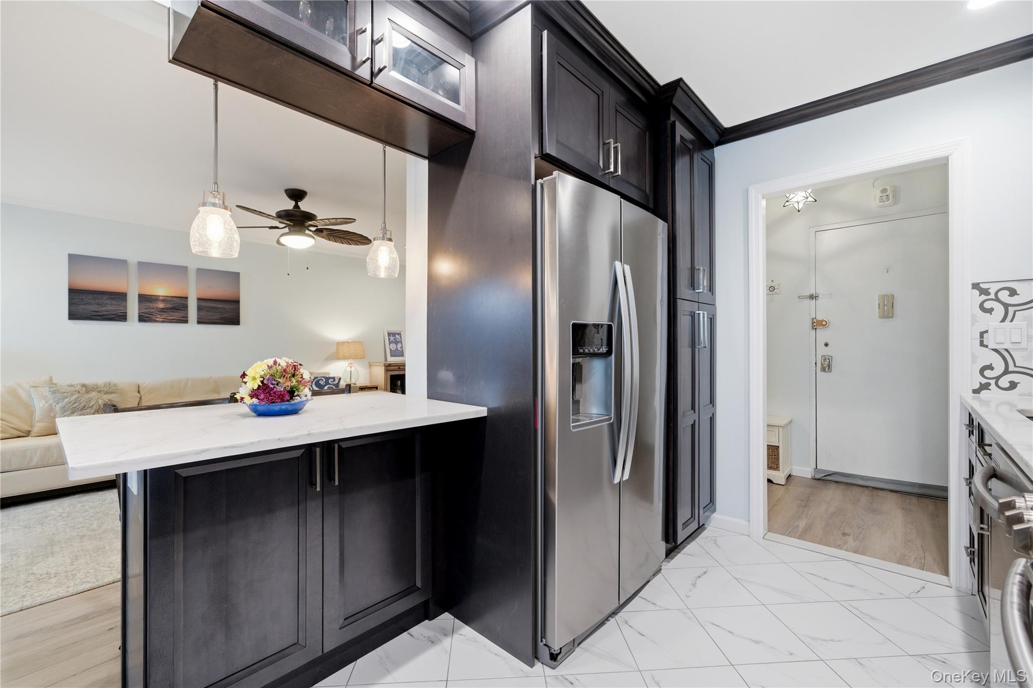 420 Shore Road, Unit 3M Long Beach, NY 11561 - Photo 21 of 21 Kitchen featuring stainless steel fridge, open floor plan, light stone counters, light marble finish floors, and crown molding