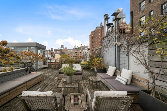 a bedroom with furniture and a large window
