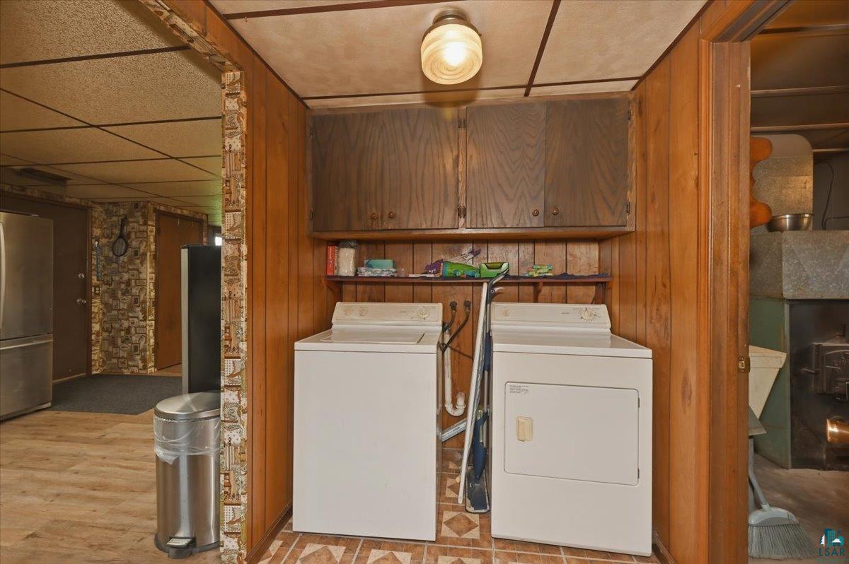 5190 County Road M Gordon, WI 54838 - Photo 11 of 31 Dedicated laundry area featuring wood-finish paneling and overhead cabinetry