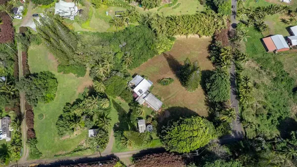 a view of a house with a yard and a wooden deck