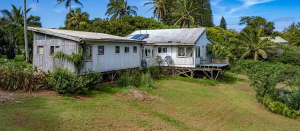 a aerial view of a house with a yard table and chairs