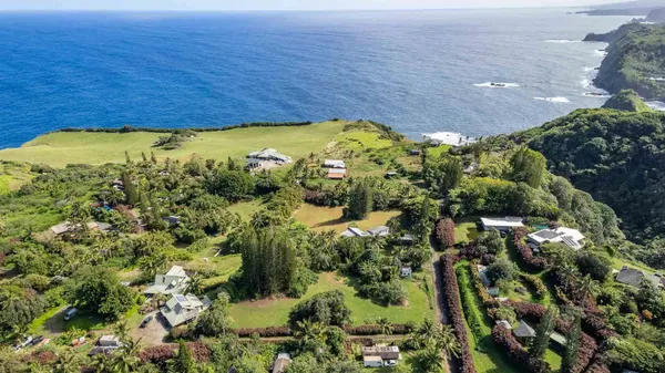 an aerial view of a house with a yard basket ball court and outdoor seating