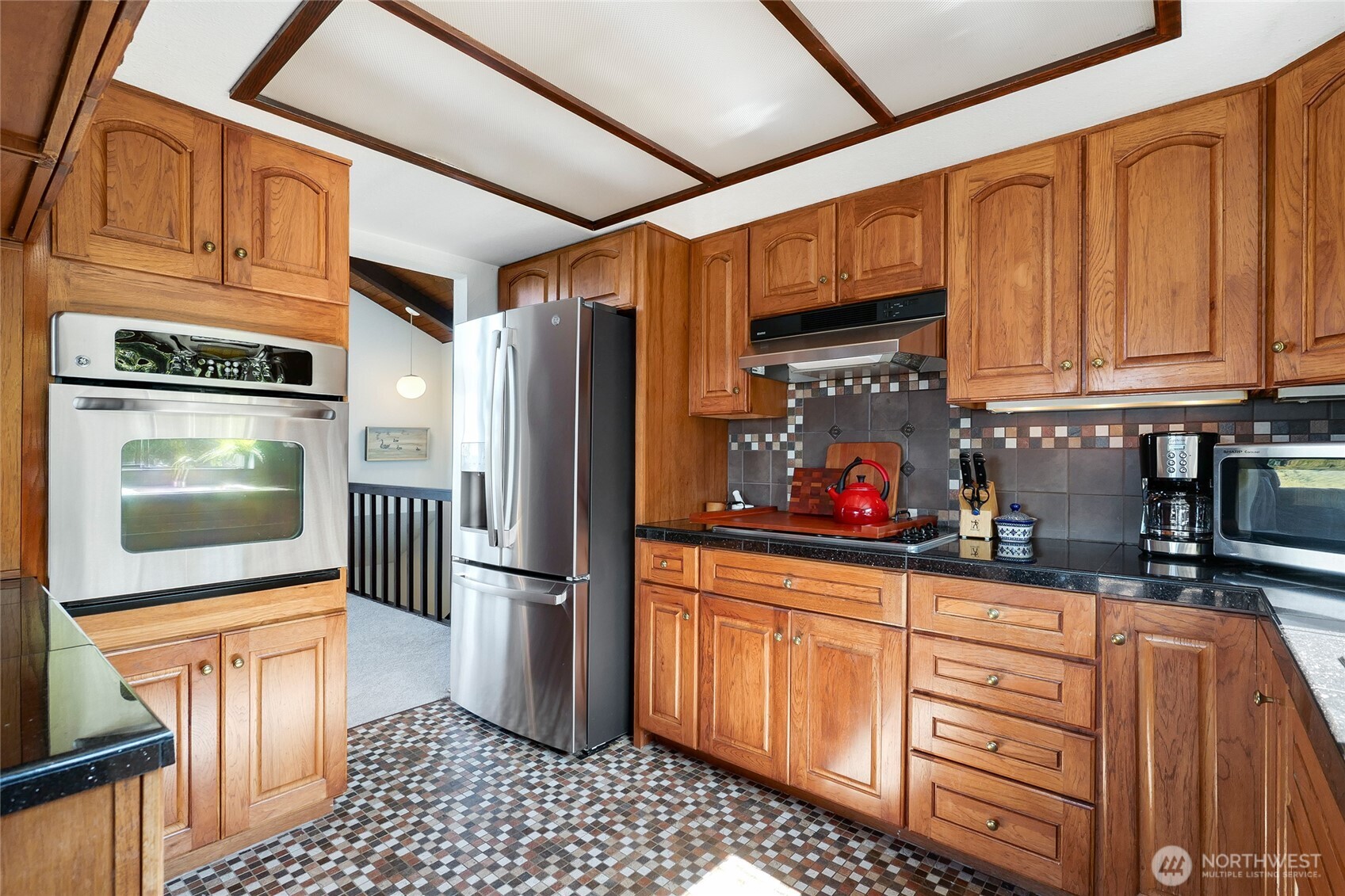 6809 Southwest Maury Park Road Vashon, WA 98070 - Photo 11 of 37 a kitchen with stainless steel appliances granite countertop a refrigerator and a stove top oven