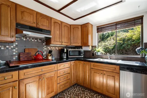 a kitchen with stainless steel appliances granite countertop a sink and cabinets