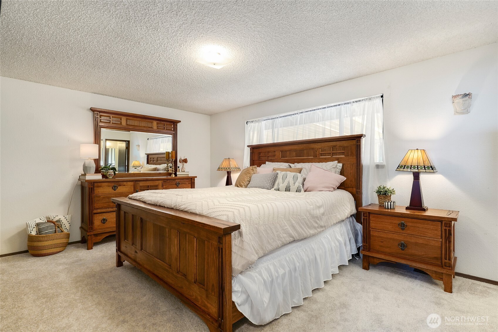6809 Southwest Maury Park Road Vashon, WA 98070 - Photo 16 of 37 a bedroom with a bed and a dresser next to a window
