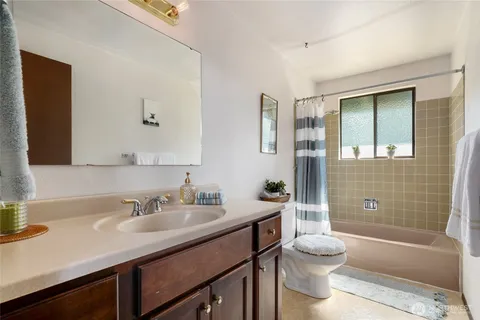 a bathroom with a sink toilet tub and shower