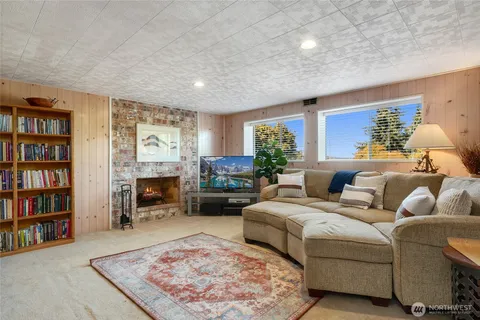 a living room with furniture and a book shelf