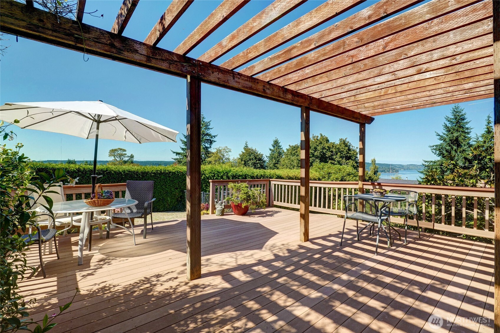 6809 Southwest Maury Park Road Vashon, WA 98070 - Photo 26 of 37 a view of a patio with a table and chairs under an umbrella