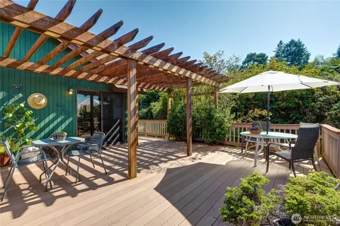 a view of a patio with table and chairs under an umbrella