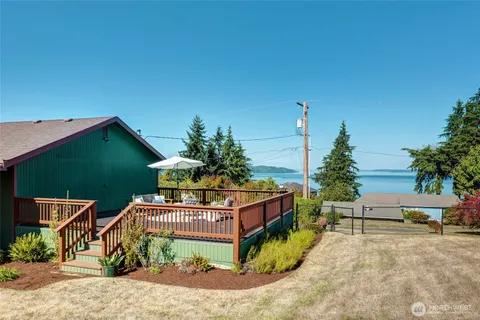 a view of a chairs and table in the backyard