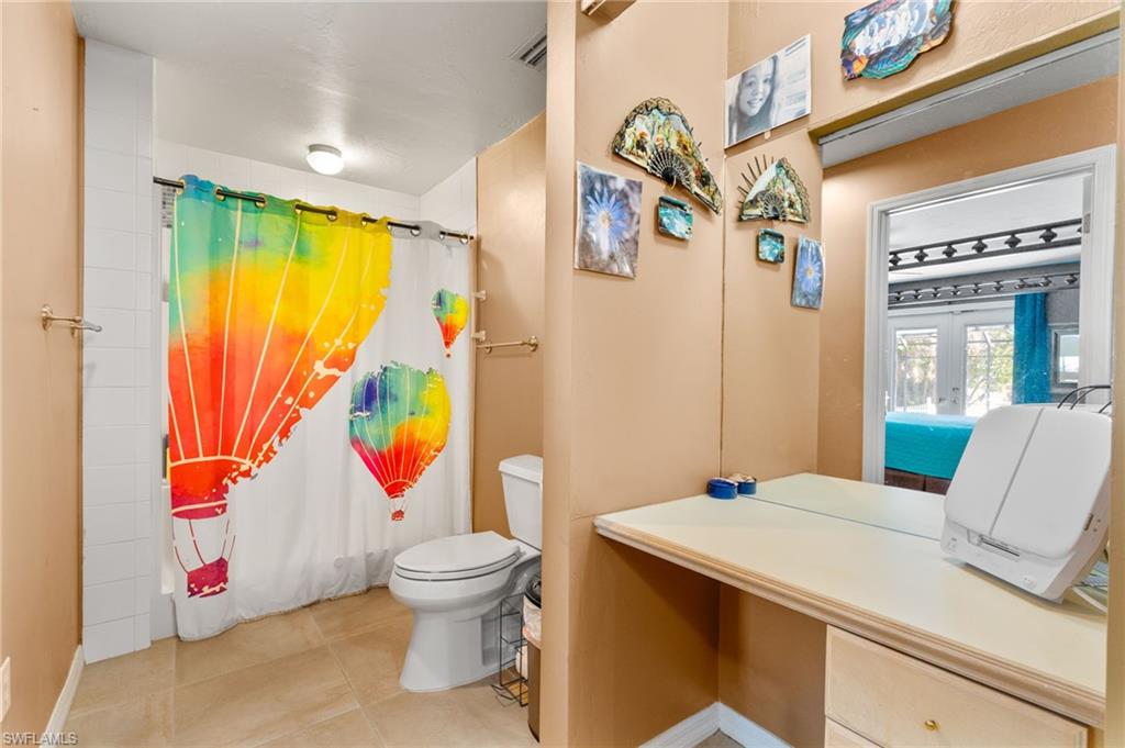 360 16th Avenue Northwest Naples, FL 34120 - Photo 11 of 25 a bathroom with a sink and mirror with toilet