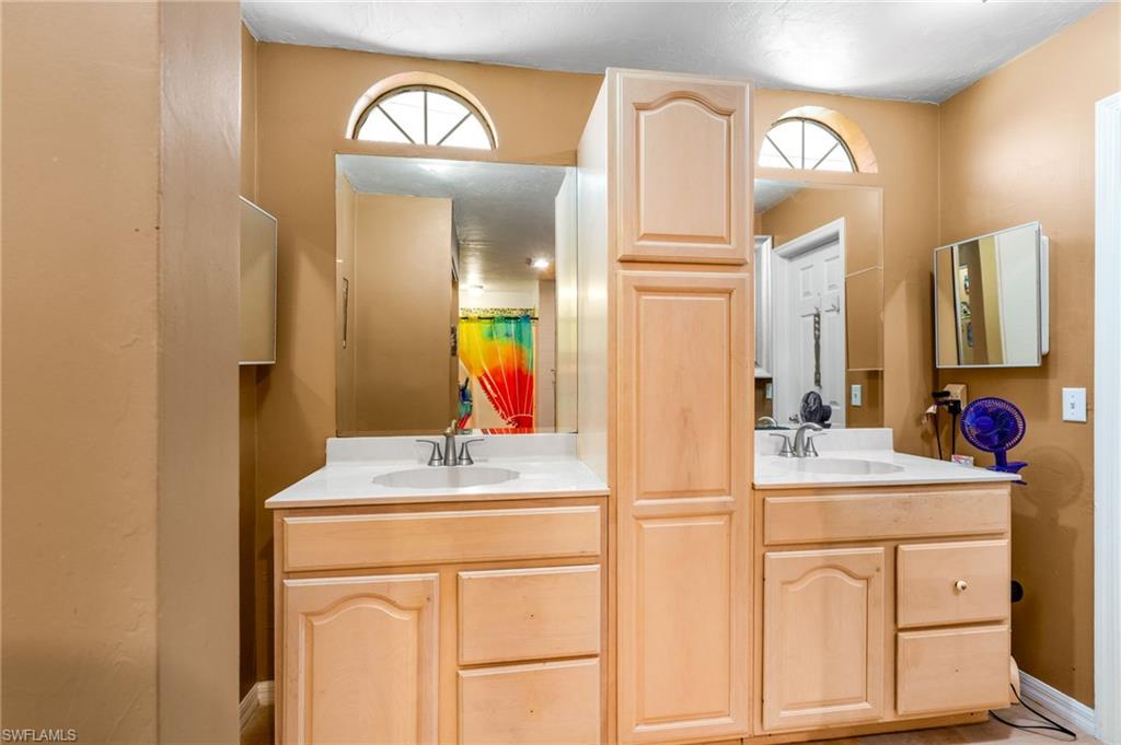 360 16th Avenue Northwest Naples, FL 34120 - Photo 12 of 25 a bathroom with a sink vanity and a mirror