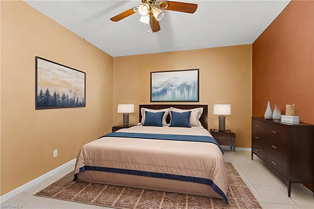 360 16th Avenue Northwest Naples, FL 34120 - Photo 13 of 25 a bedroom with bed and wooden floor