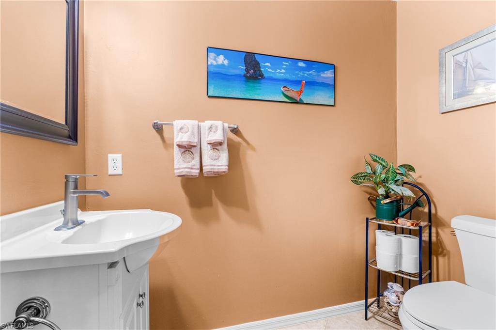 360 16th Avenue Northwest Naples, FL 34120 - Photo 14 of 25 a bathroom with a sink a toilet and a mirror