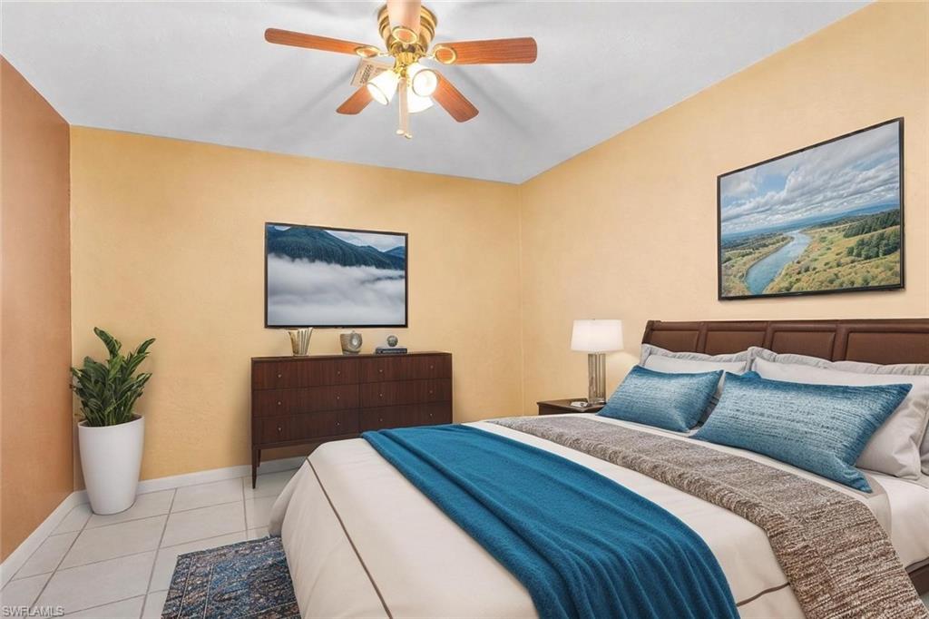 360 16th Avenue Northwest Naples, FL 34120 - Photo 15 of 25 a bedroom with a bed and a chandelier