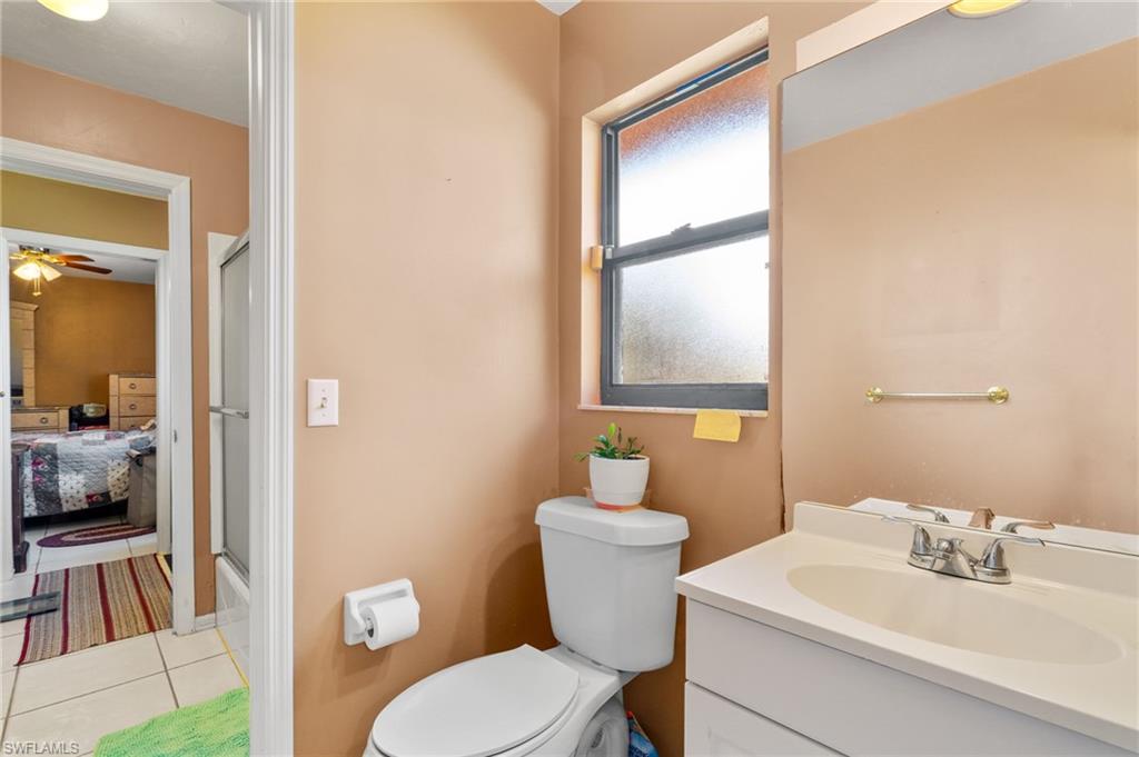 360 16th Avenue Northwest Naples, FL 34120 - Photo 16 of 25 a bathroom with a sink vanity mirror and toilet