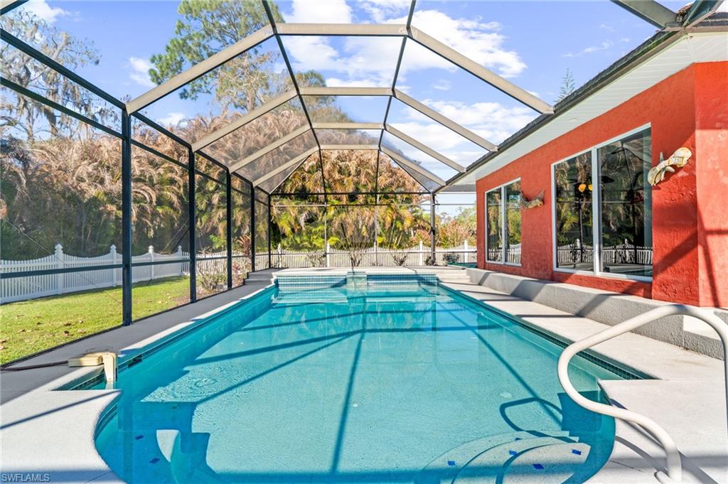 360 16th Avenue Northwest Naples, FL 34120 - Photo 17 of 25 a swimming pool with large glass windows and painted walls