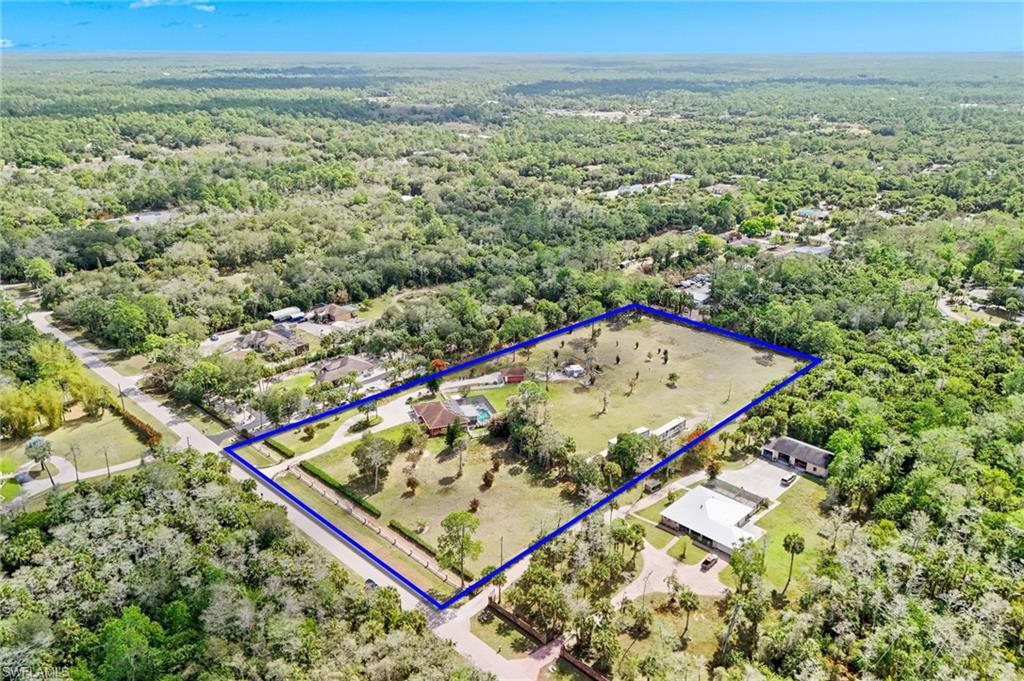 360 16th Avenue Northwest Naples, FL 34120 - Photo 23 of 25 an aerial view of a residential house with an outdoor space and seating area