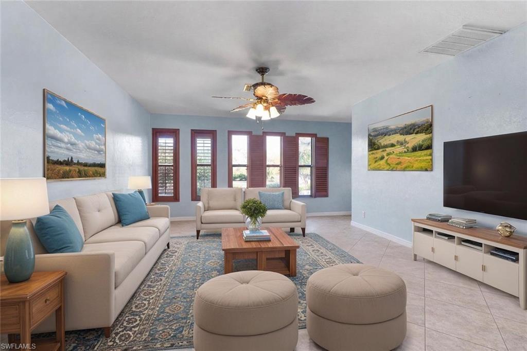 360 16th Avenue Northwest Naples, FL 34120 - Photo 3 of 25 a living room with furniture a chandelier and a flat screen tv