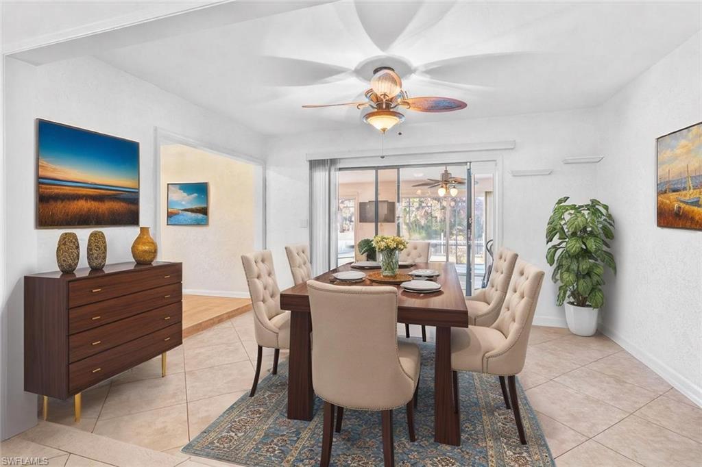 360 16th Avenue Northwest Naples, FL 34120 - Photo 7 of 25 a view of a dining room with furniture a livingroom and chandelier